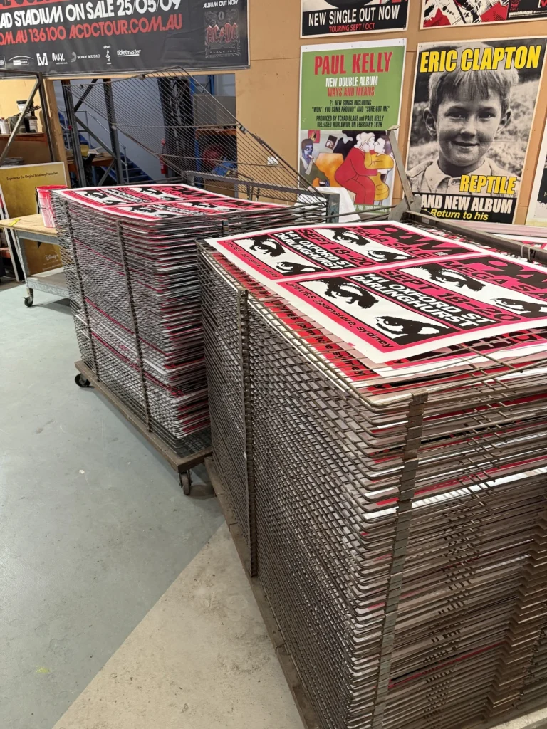 screen printed posters on drying rack